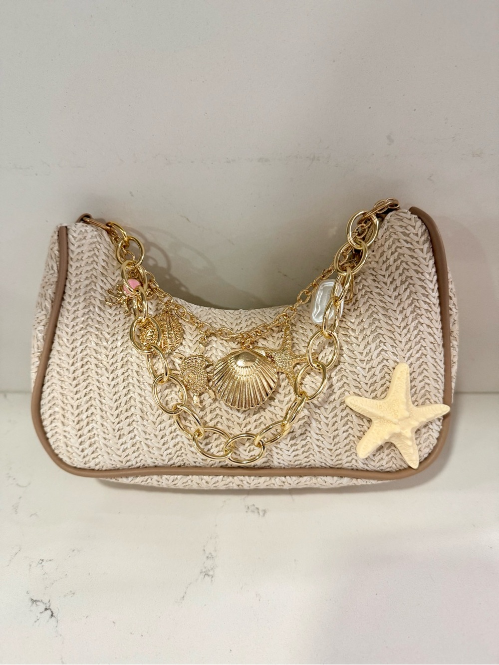 Beige Woven Shoulder Bag with Gold Chain and Shell Accents